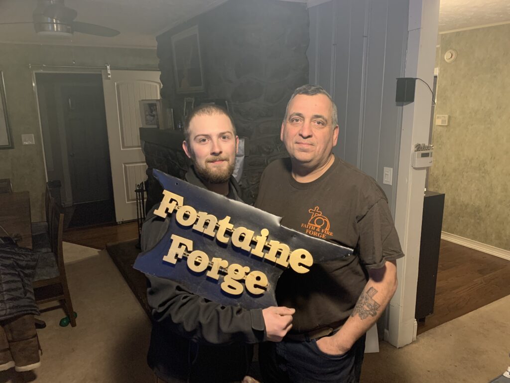 blacksmiths with sign Fontaine Forge